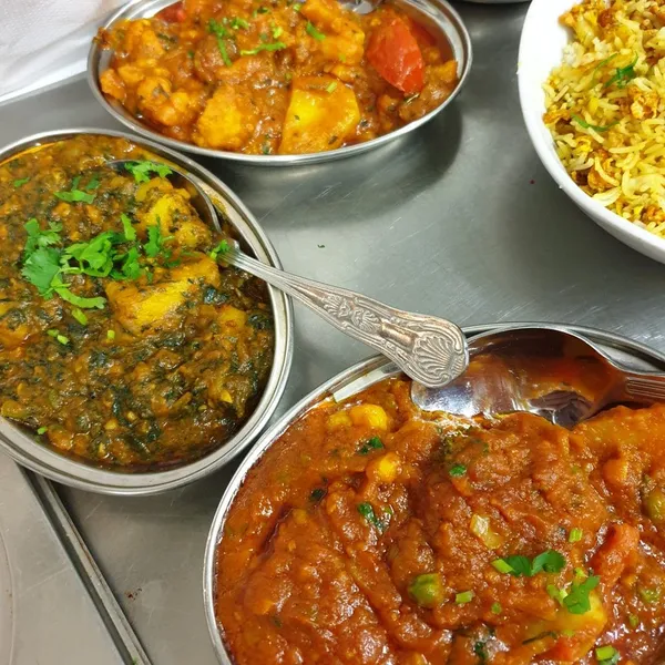 A spread of dal, rice and accompaniments arranged for a relaxed meal.
