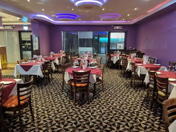 A comfortable Spice Room dining area with upholstered seating and warm lighting.
