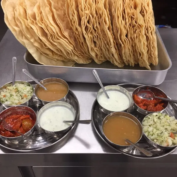 A starter platter with crisp fried bites, salad and dipping sauces.